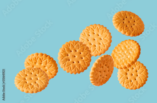 round cookie flying on a blue background, copy space