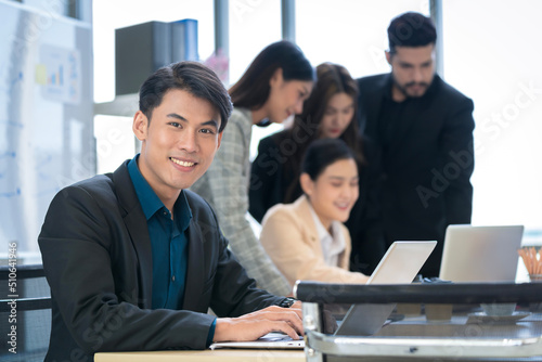 Asian businessman looking at the camera Working and meeting at the office at the company with colleagues at the back