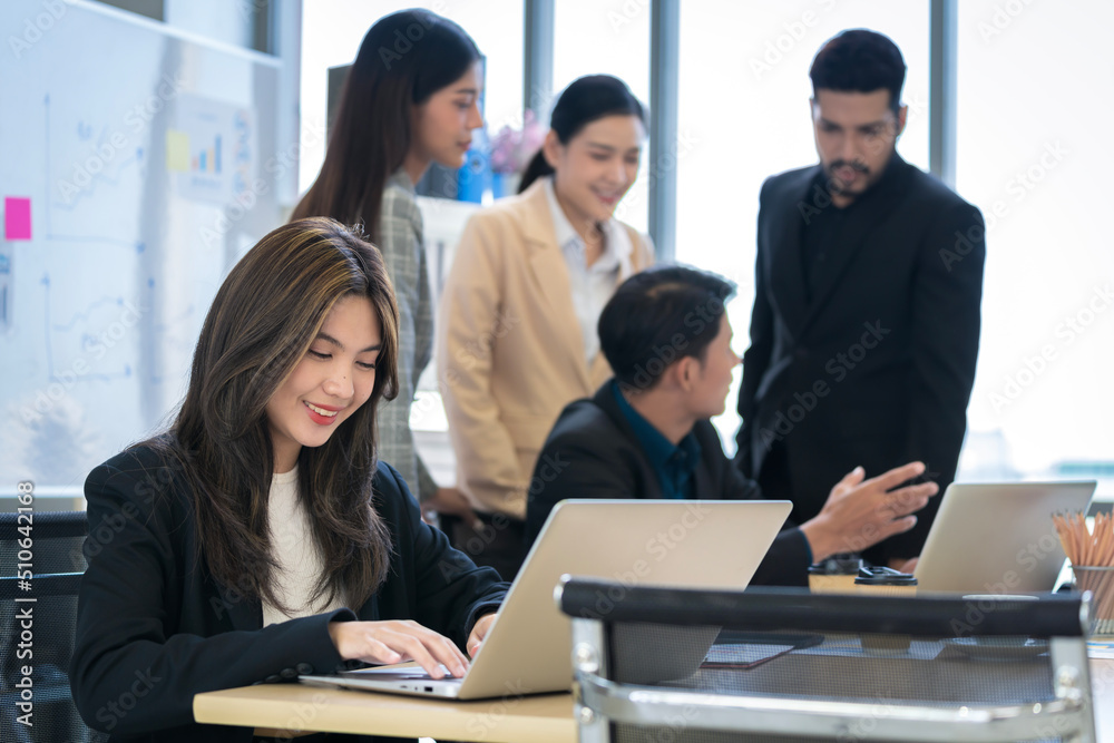Asian businessman Working and meeting at the office at the company with colleagues at the back Asian businessman Working and meeting at the office at the company with colleagues at the back