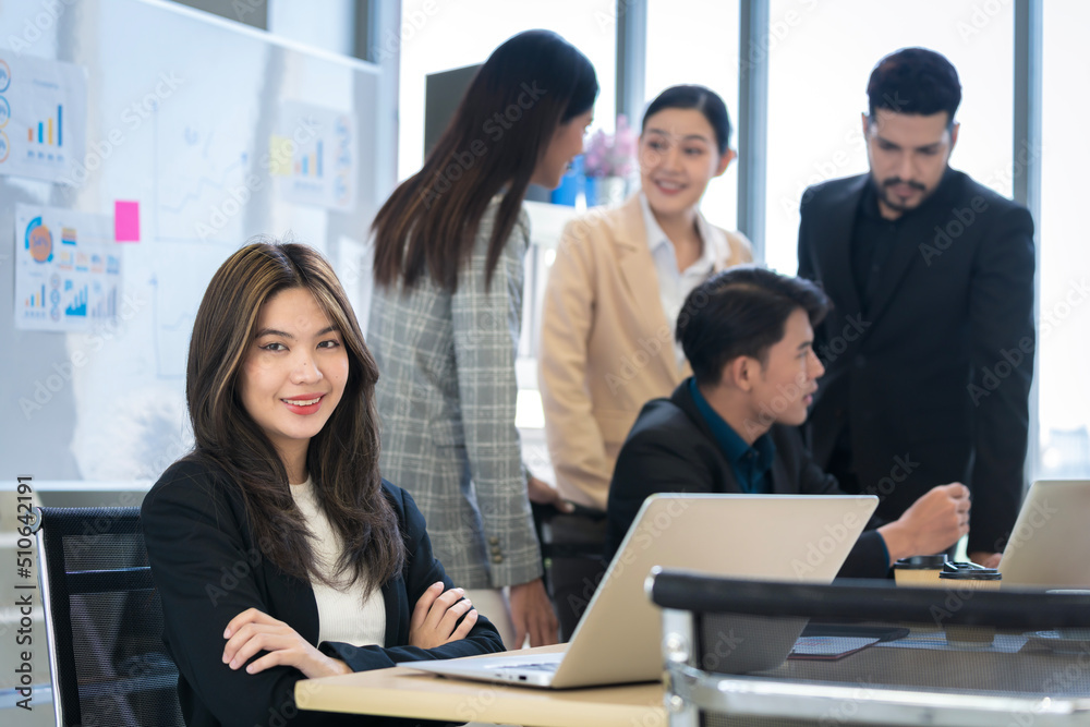 Asian businessman looking at the camera Working and meeting at the office at the company with colleagues at the back