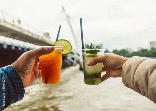 hands holding cocktail