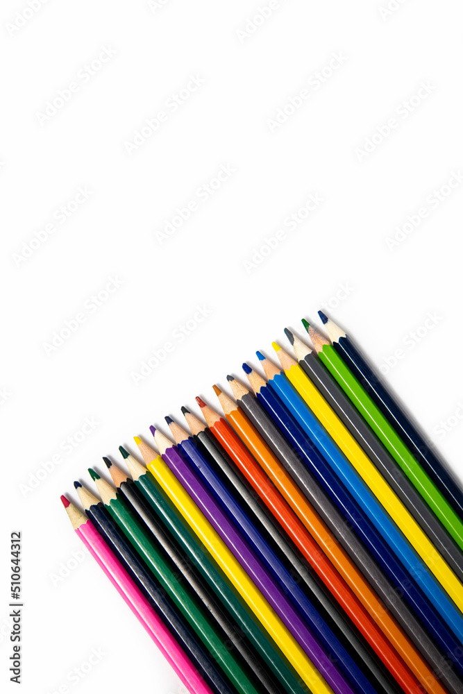 Many multi-colored pencils on a white background. Top view, flat lay. Many multi-colored pencils on a white background. Top view, flat lay.