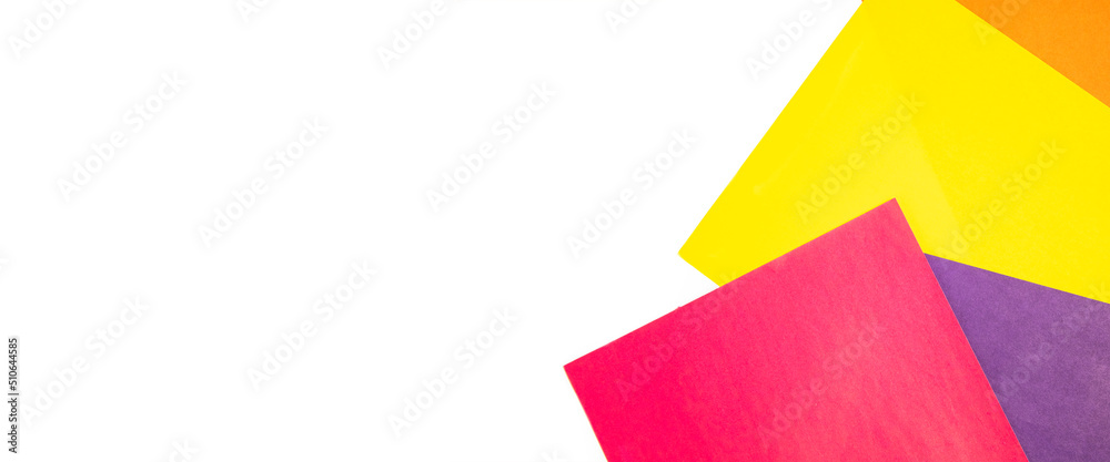 Colored paper on white background. Top view, flat lay. Banner Colored paper on white background. Top view, flat lay. Banner