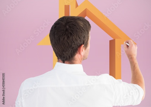 Caucasian man writing on an invisible screen with house icon and copy space on pink background