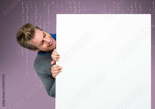 Caucasian man holding a blank placard with copy space against data processing on purple background