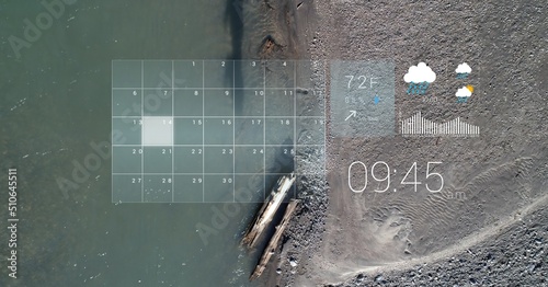 Digital interface with data processing over aerial view of sea and land