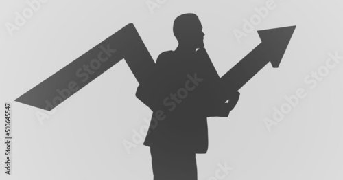 Silhouette of a man with upward arrow against copy space on grey background photo