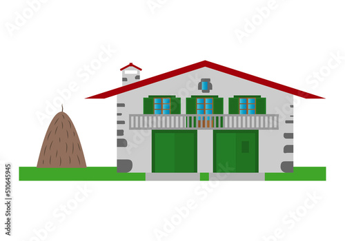Caserío del País Vasco. Casa rural con puertas y persianas verdes y montículo de abono