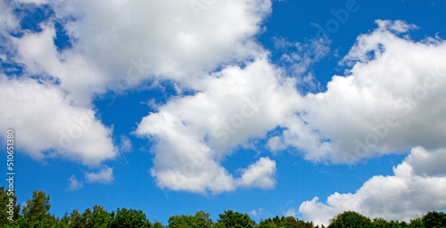 Sunny background with blue sky and white clouds as summer natural background.