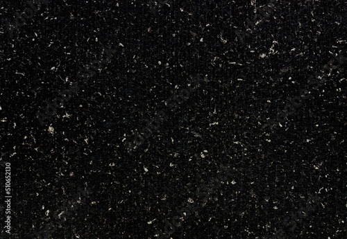dark black real terrazzo cement wall with shallow groove pattern. close up view of black concrete wall texture with white grain use as background. wall surface consists of marble and granite element.
