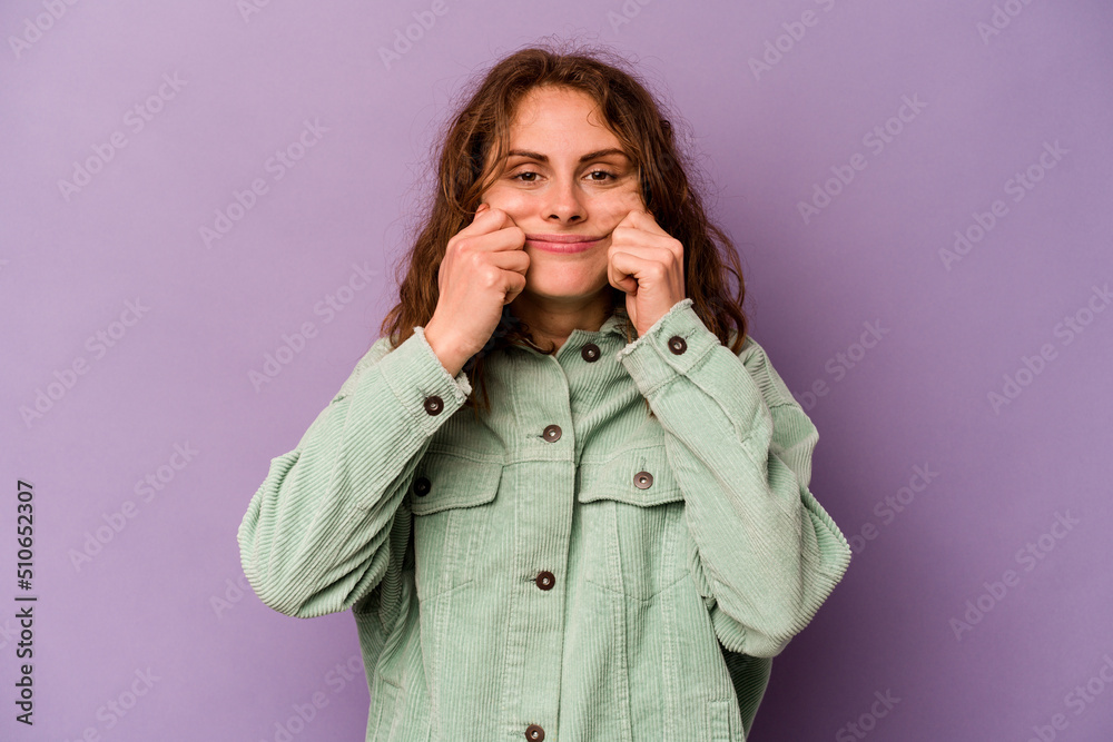 Young caucasian woman isolated on purple background doubting between two options. Young caucasian woman isolated on purple background doubting between two options.