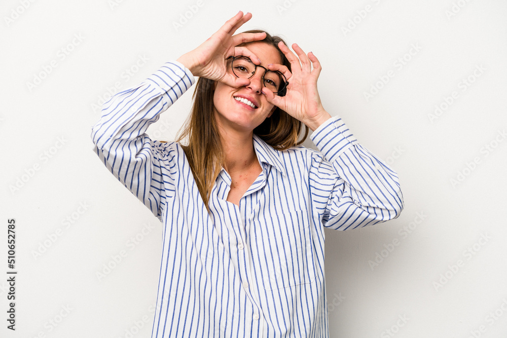 Young caucasian pregnant woman isolated on white background showing okay sign over eyes