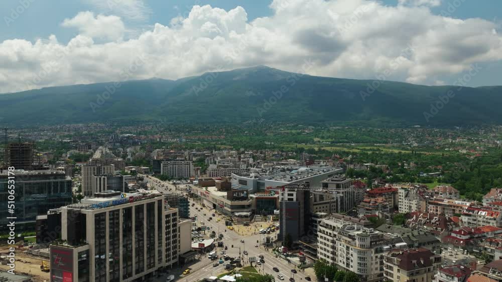 View of the city timelapse. A busy intersection in a big city with a mountain in the background. Fast clouds. Timelapse Sofia - Cherni vrah and Peradise Mall. View of the city timelapse. A busy intersection in a big city with a mountain in the background. Fast clouds. Timelapse Sofia - Cherni vrah and Peradise Mall.