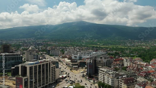 View of the city timelapse. A busy intersection in a big city with a mountain in the background. Fast clouds. Timelapse Sofia - Cherni vrah and Peradise Mall.  photo
