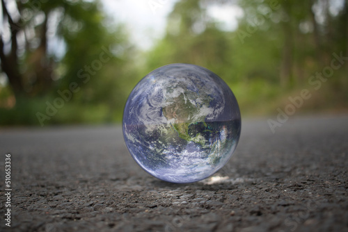 Lensball - Strasse - Erde - Earth - Ecology - High quality photo - Bioeconomy - A closeup of lensball with reflection planet on ground