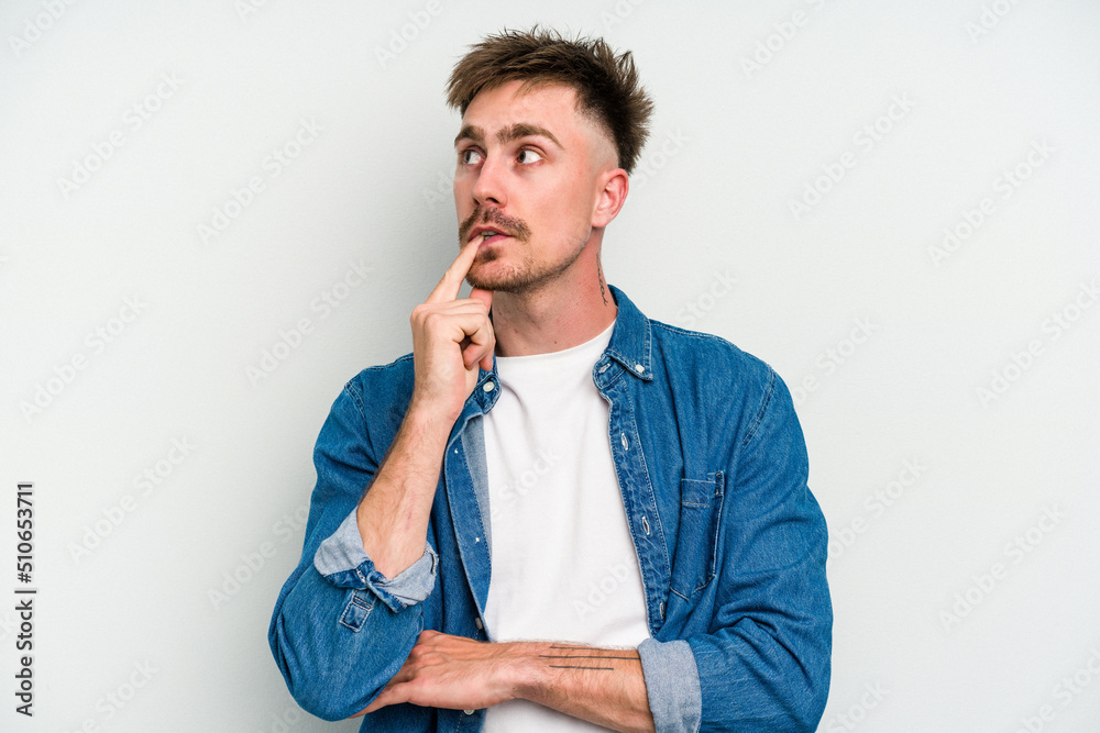 Young caucasian man isolated on white background looking sideways with doubtful and skeptical expression. Young caucasian man isolated on white background looking sideways with doubtful and skeptical expression.