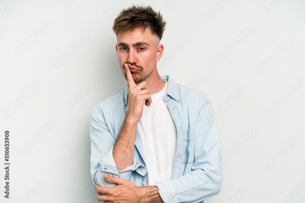 Young caucasian man isolated on white background unhappy looking in camera with sarcastic expression. Young caucasian man isolated on white background unhappy looking in camera with sarcastic expression.