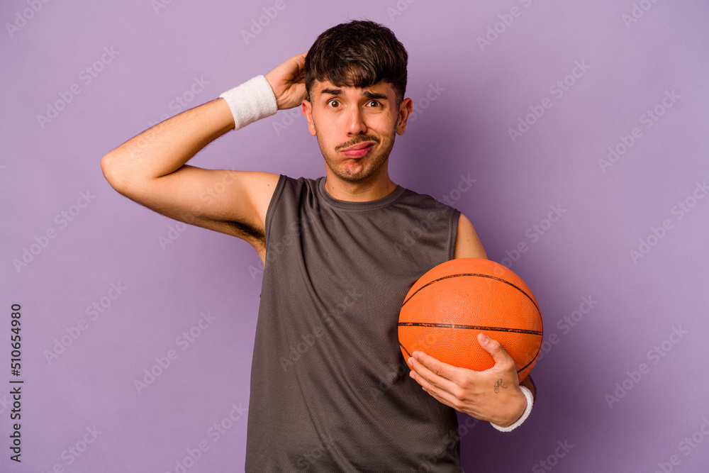 Young hispanic basketball player man isolated on purple background being shocked, she has remembered important meeting.