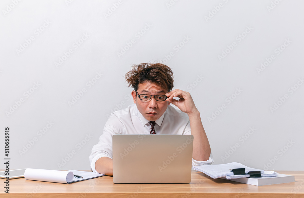 Asian business man sitting and working and stressed Asian business man sitting and working and stressed