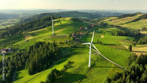 wind farm on green rolling hills in rural area in Europe, renewable energy and sustainable development concept, wind turbines in green meadows, alternative energy, natural electricity  photo