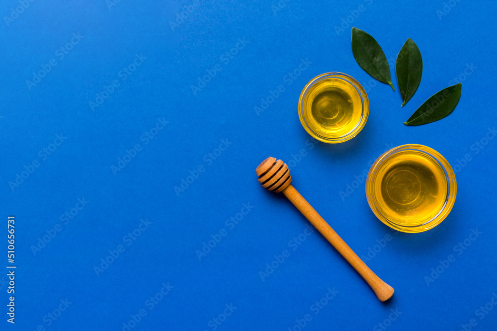 Honey jar with wooden honey dipper on white background top view with copy space. Delicious honey bottle Honey jar with wooden honey dipper on white background top view with copy space. Delicious honey bottle