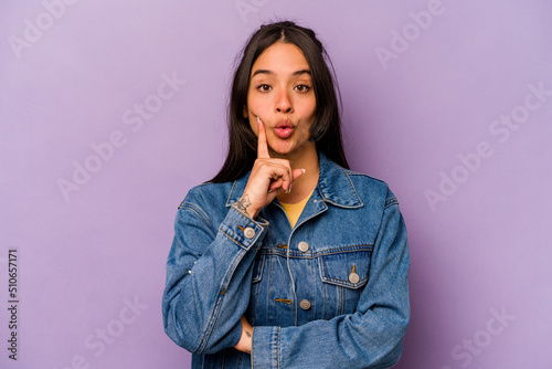 Young hispanic woman isolated on purple background having some great idea, concept of creativity.