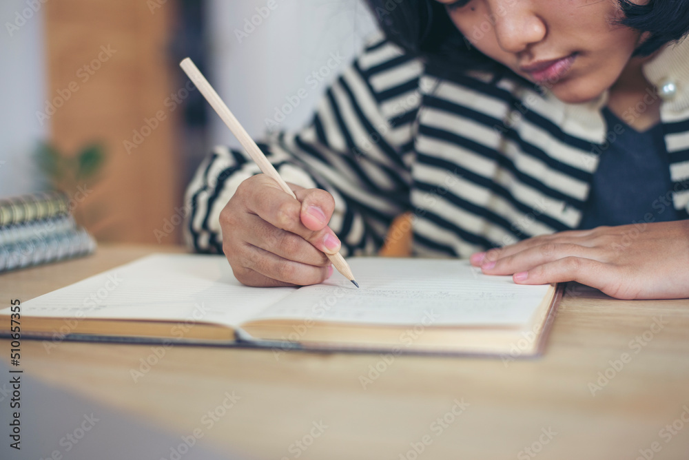 Asian elementary Children Writing Letter on diary book. Kid learn and work, read book, girl work at home. Cute Child doing and study homework. Little Child happy and smile. Education concept. Asian elementary Children Writing Letter on diary book. Kid learn and work, read book, girl work at home. Cute Child doing and study homework. Little Child happy and smile. Education concept.