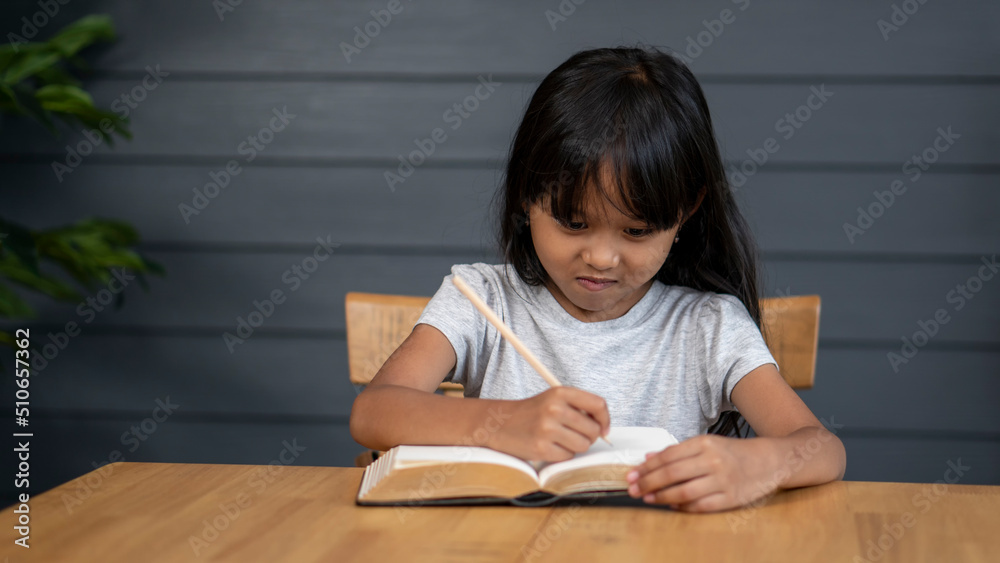 Asian elementary Children Writing Letter on diary book. Kid learn and work, read book, girl work at home. Cute Child doing and study homework. Little Child happy and smile. Education concept. Asian elementary Children Writing Letter on diary book. Kid learn and work, read book, girl work at home. Cute Child doing and study homework. Little Child happy and smile. Education concept.