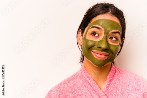 Young hispanic woman wearing facial mask isolated on white background