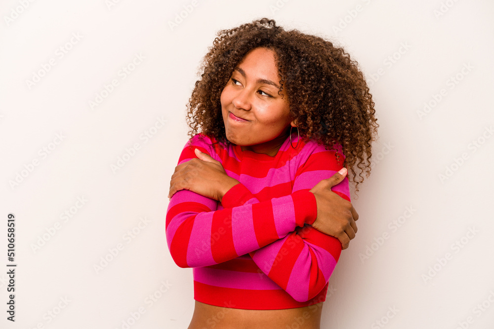 Young African American woman isolated on white background hugs, smiling carefree and happy. Young African American woman isolated on white background hugs, smiling carefree and happy.