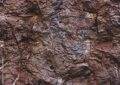 Wall marble. Brown texture. Stone background. Rock texture. Grunge Rough structure. Abstract texture. Rock surface with cracks. Rock pile. Paint spots wall.