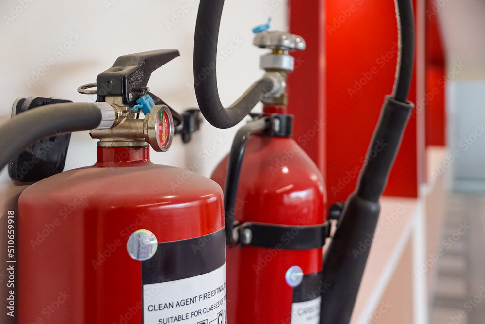 Fire extinguisher and gas pump system on the wall. Powerful emergency fire extinguisher equipment. Fire retardant. Fireproof.