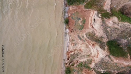 Vertical aerial top down view shot and looking down on Dnipro river and green hills in Stanislav, Kherson, Ukraine