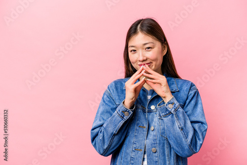 Young Chinese woman isolated on pink background making up plan in mind, setting up an idea.