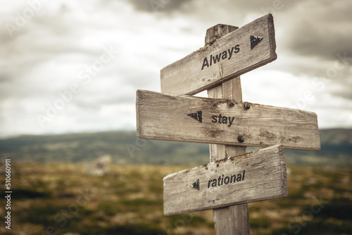 always stay rational text quote on wooden signpost outdoors in nature. Inflation, economy and finance concept.