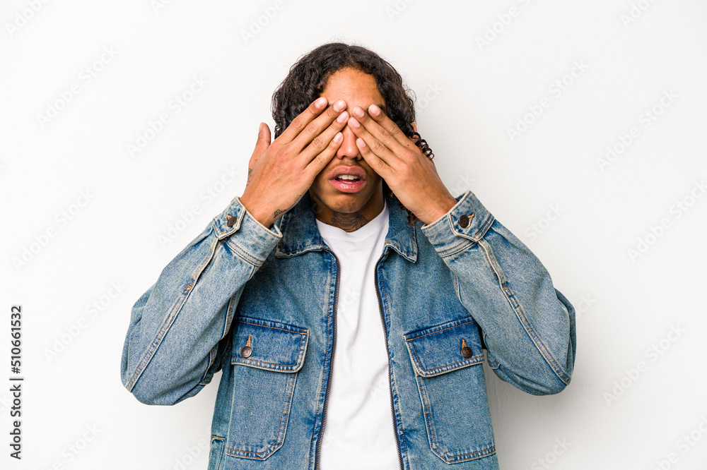 Young African American man isolated on white background afraid covering eyes with hands. Young African American man isolated on white background afraid covering eyes with hands.