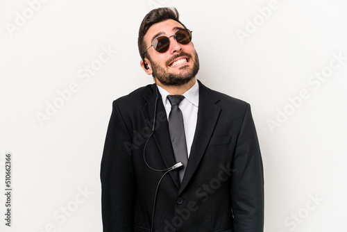 Young caucasian bodyguard man isolated on white background dreaming of achieving goals and purposes