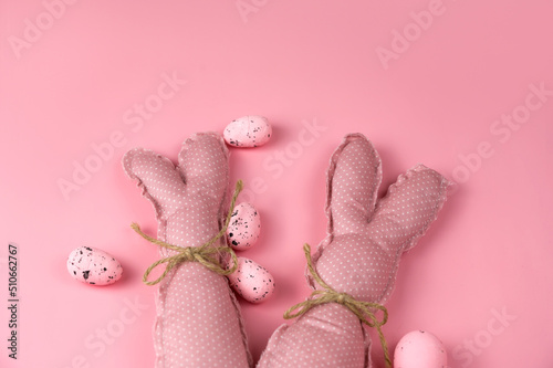 Fototapeta Naklejka Na Ścianę i Meble -  Pink toy bunnies on pink background .Easter banner. Greetings card