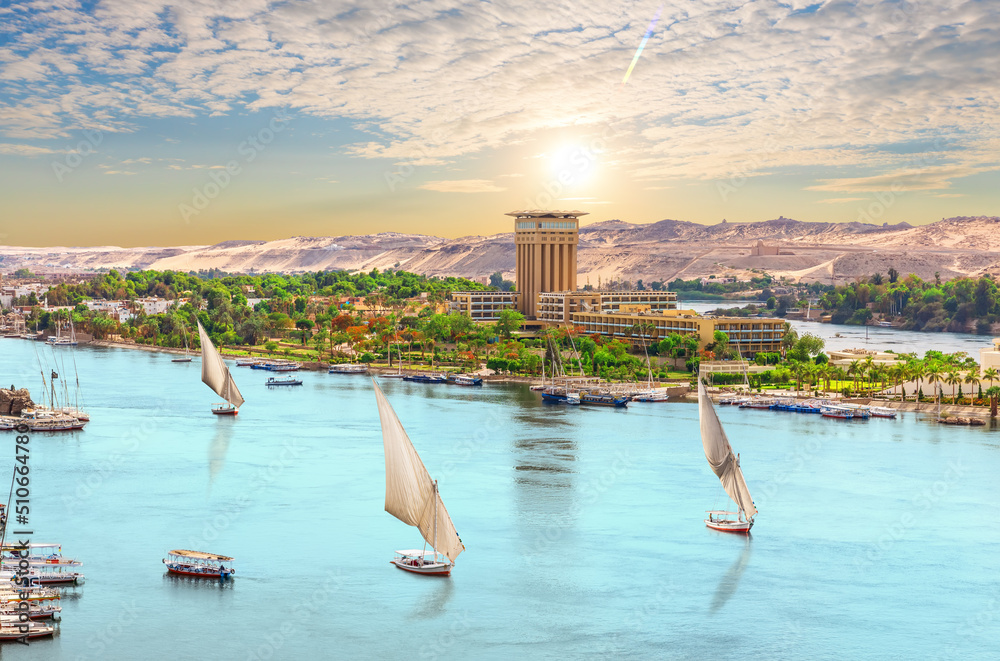 Sailboats of the Nile, beautiful sunset over Aswan city, Egypt