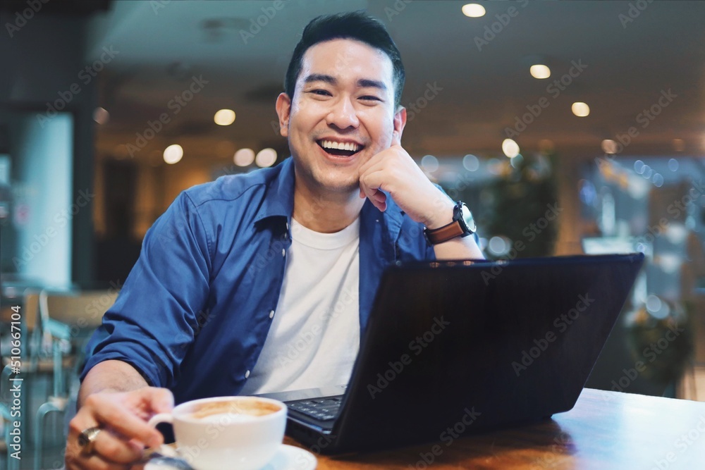 man with laptop in cafe