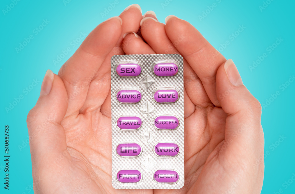 Female hands holding pack of purple pills that fulfill dreams, desires and wishes. Blue background. The concept of choice and drugs Female hands holding pack of purple pills that fulfill dreams, desires and wishes. Blue background. The concept of choice and drugs
