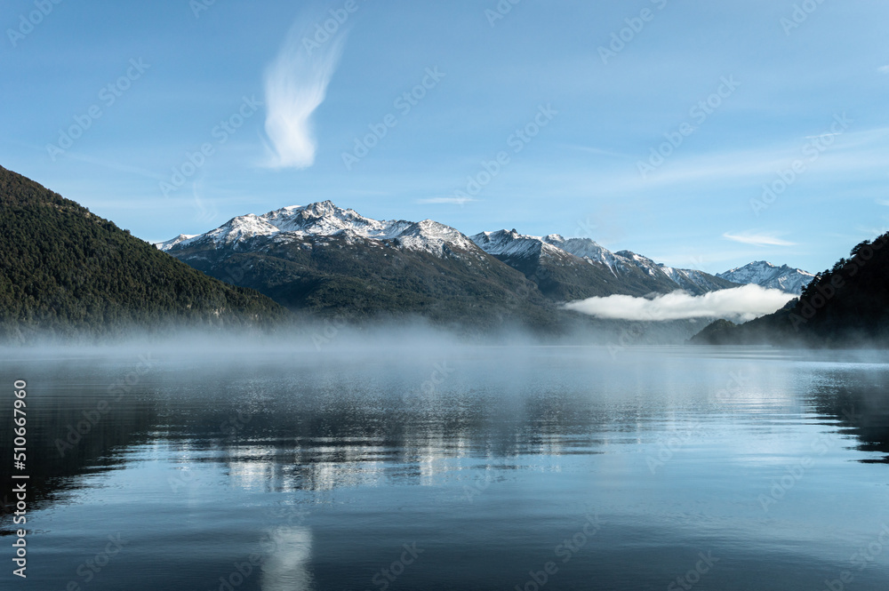 beautiful sunrise with fog over a lake in the Andes mountain range. Lake Gutierrez, Los Alerces National Park