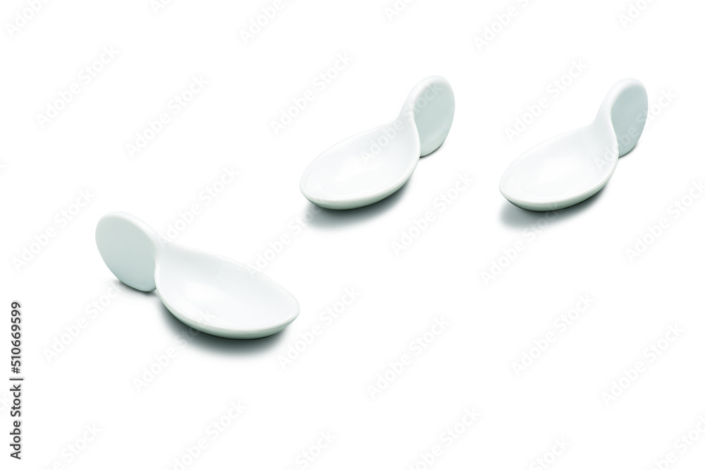 Three empty modern oval white porcelain sauce cups, isolated on white Three empty modern oval white porcelain sauce cups, isolated on white