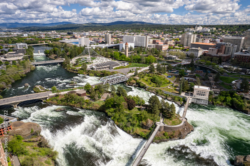 Wide angle view of downtown Spokane, WA cityscape with view of pavilion and Spokane River during the day, United States