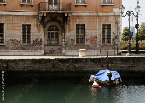 Trieste, Italy - cityscape with the ancient Palazzo Carciotti and the Canal Grande, navigable canal in city center built in 18th century. photo