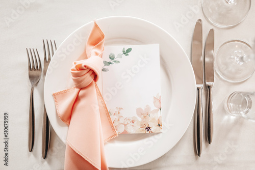 Luxury table setting for dining in a restaurant in pastel colors close up. Wedding party table set for banquet