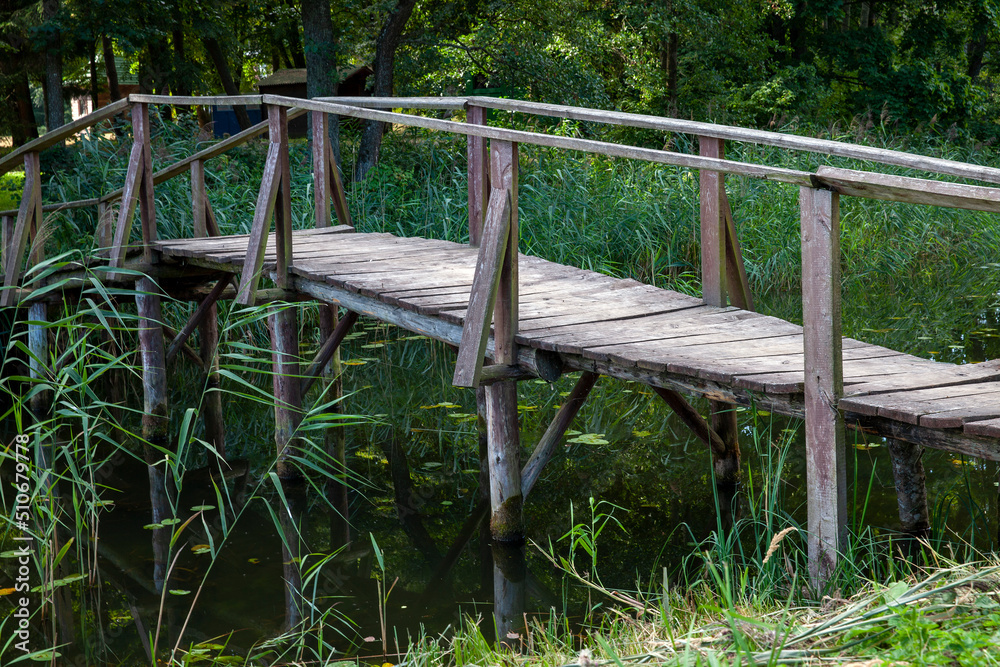 old wooden bridge over a small river old wooden bridge over a small river