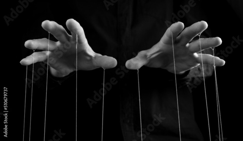 Man hands with strings on fingers. Negative abusive relationship, manipulation, control, power concept. Black and white. High quality photo
