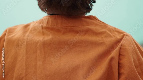 Boy wearing orange kimono over the shoulder