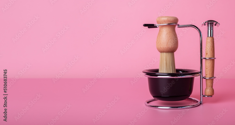 Shaving kit for men, razor, brush, cup for foam in vintage retro style. Grooming set on pink background with copy space for text. High quality photo Shaving kit for men, razor, brush, cup for foam in vintage retro style. Grooming set on pink background with copy space for text. High quality photo